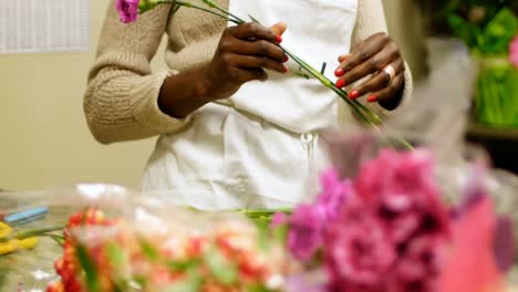 female florist preparing flower bouquet 4k