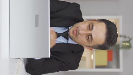 Vertical-video-of-Home-office-worker-man-stressed-and-thoughtful.