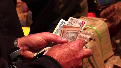 counting money to give to vendor in a himalayan market