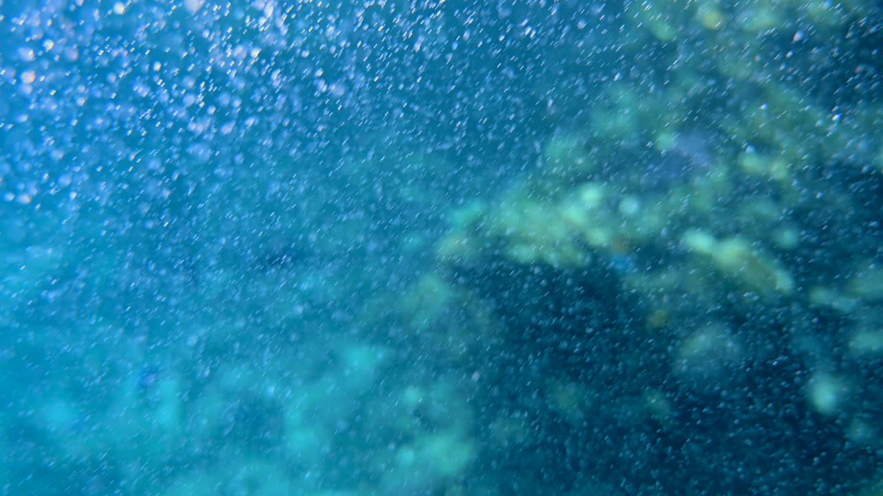 Underwater view of the waves and the bubbles of the red sea