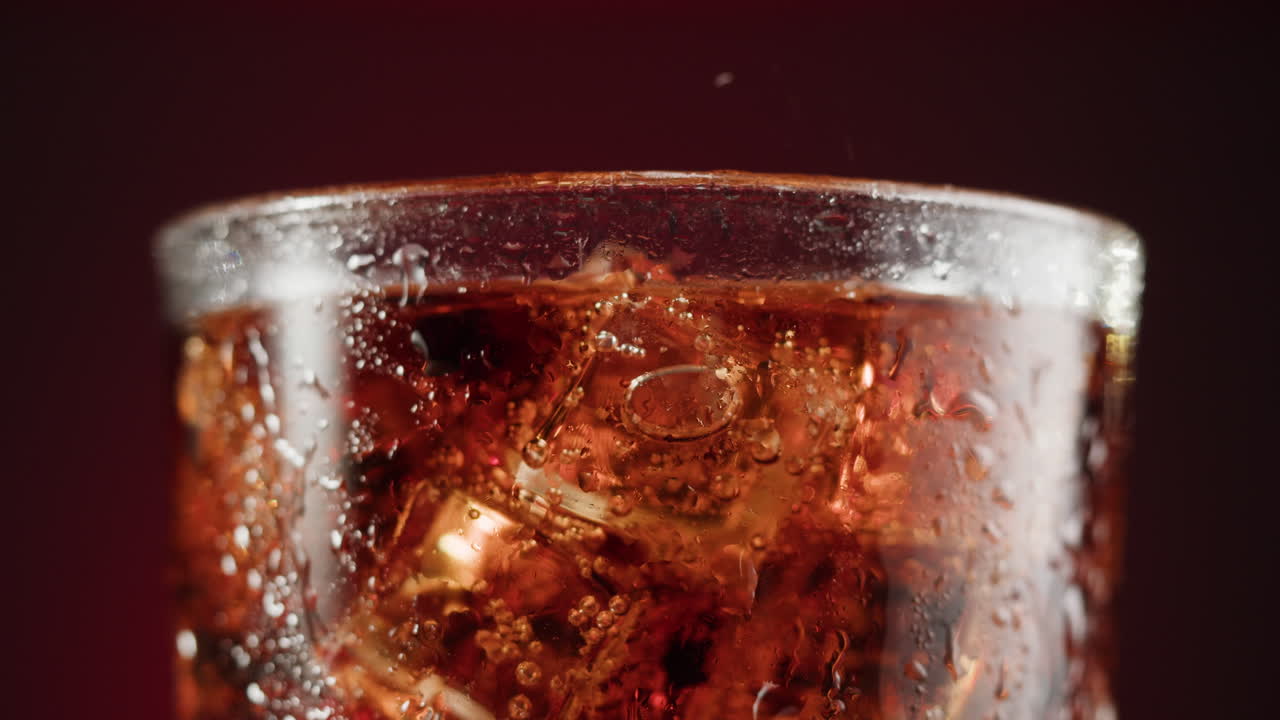Close-up of a glass of cold soda with ice