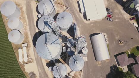 flying over grain bins on farm during summer