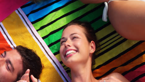 Group-of-friends-lying-on-towels