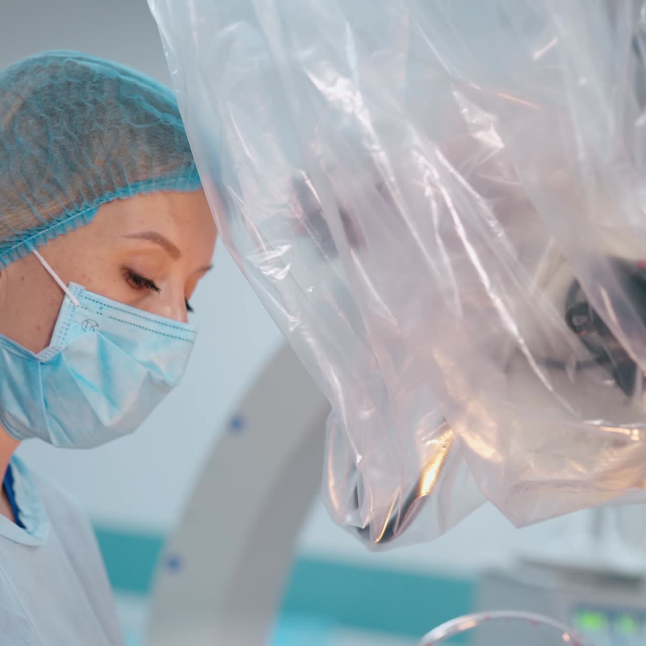 Portrait of a female doctor at work. Side view of a woman in medical mask near the modern medical equipment in hospital.