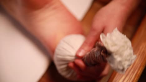 foot massage with herbal ball