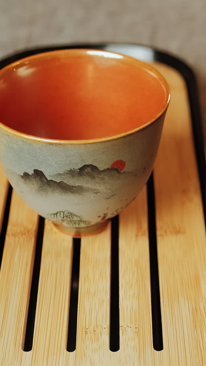 Pouring Tea into a Traditional Ceramic Cup