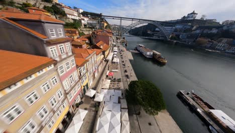 red rooftops zoom by over river side fpv drone dom luis bridge porto portugal