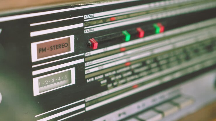 Pull focus revealing radiogram radio frequency panel listing European broadcast cities. Suitable for communication history and retro electronics visuals