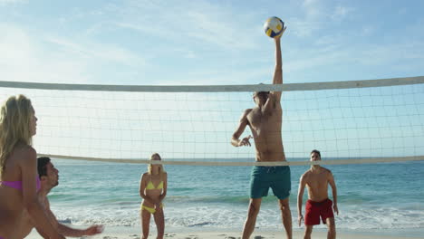 friends playing beach volleyball