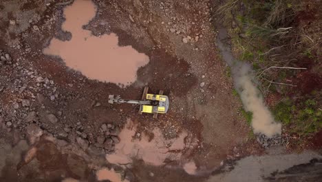 top down footage of an excavator removing rock in an open quarry in foz do iguazu, brazil