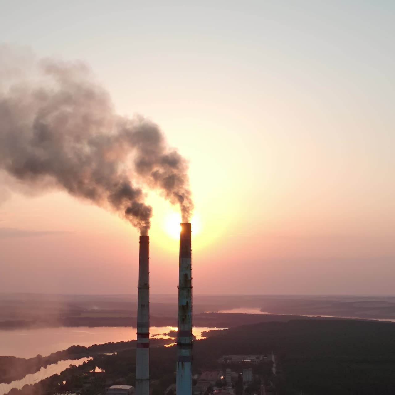 Big factory tubes smoking on sunset. Huge industrial ecology smog building