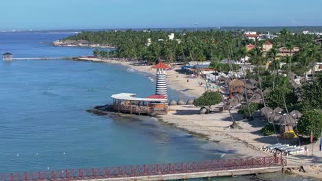 long pier and lighthouse on playa dominicus beach in dominican republic. aerial drone panoramic view