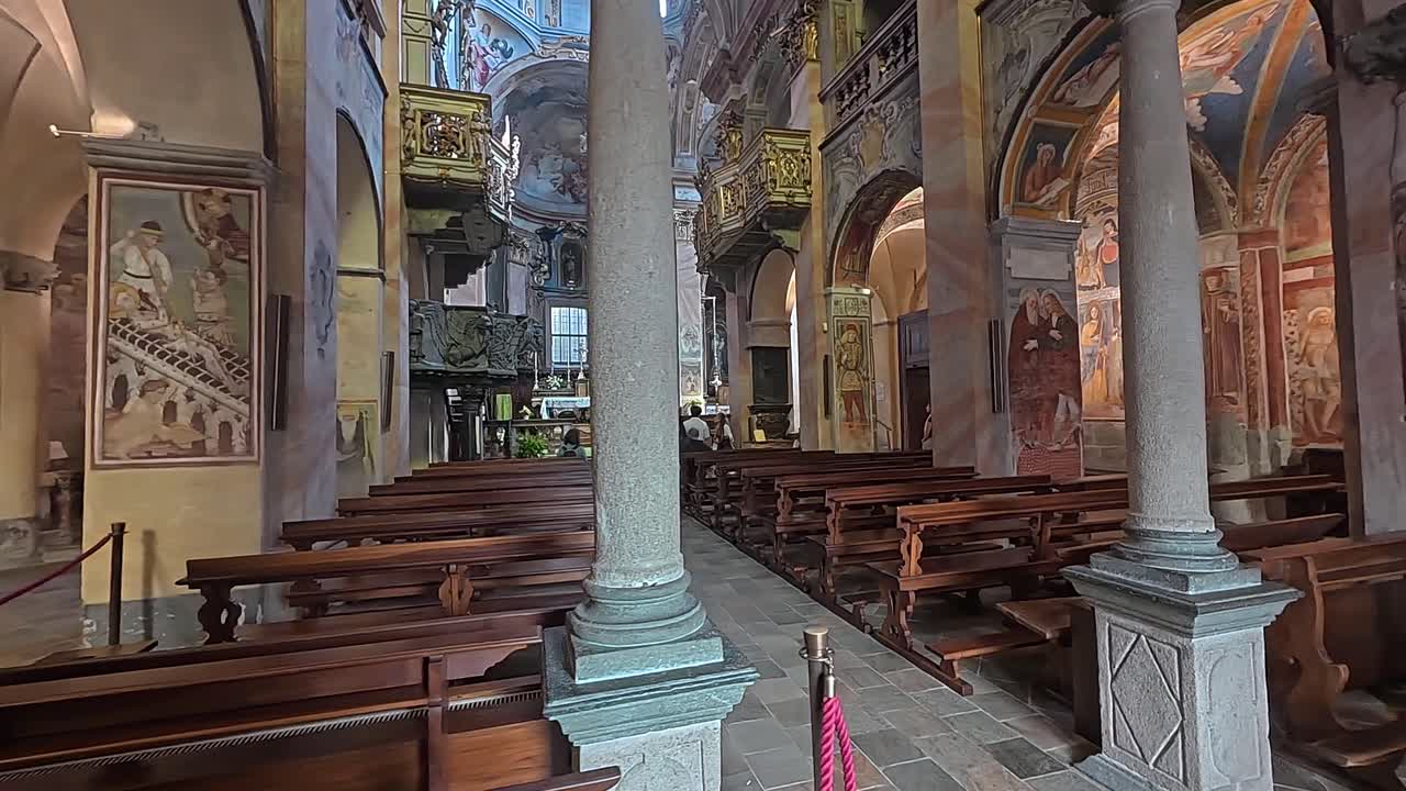 Interior view of The Basilica di San Giulio showcasing intricate frescoes and ornate architecture on Isola San Giulio in Lake Orta.