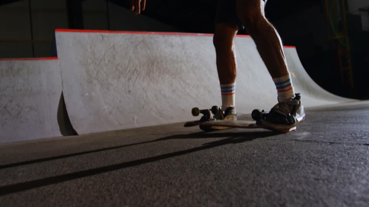 Man practicing skateboarding in skateboard arena 4k