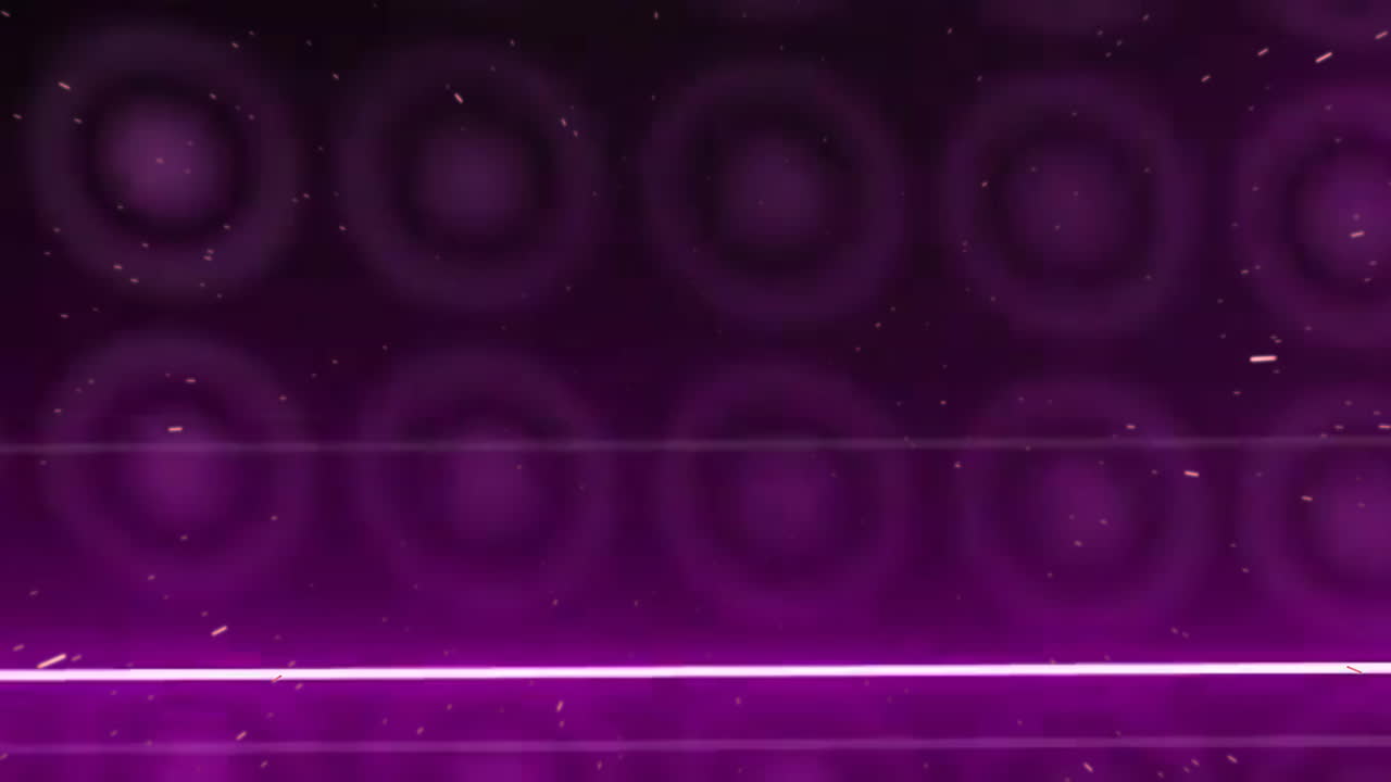 Animace zářících částic tvořících fialové kruhové vzory na tmavém pozadí.