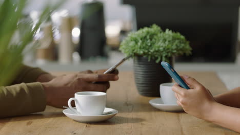 business people hands using smartphone in coffee shop texting messages sharing lifestyle on social media browsing mobile phone in relaxed cafe close up