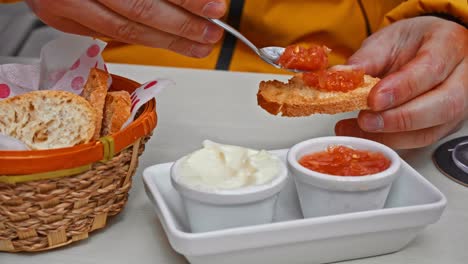 close up on aioli and tomato spread on a slice of bread