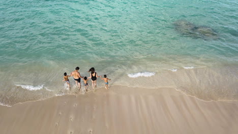 Family-Enjoying-Running-On-The-Lanikai-Beach-At-Kailua,-Hawaii