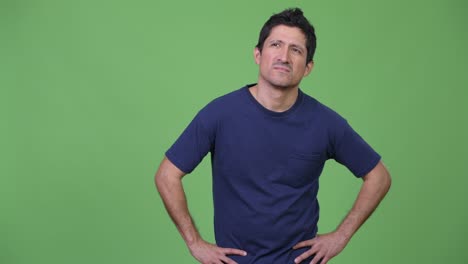 Annoyed Hispanic man looking bored