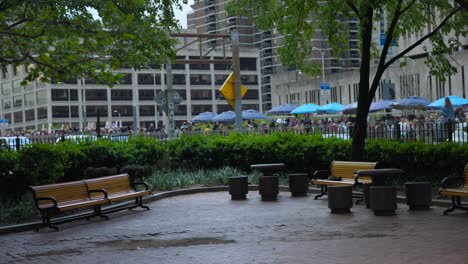 pan left across empty park with benches near entrance to brooklyn bridge in new york