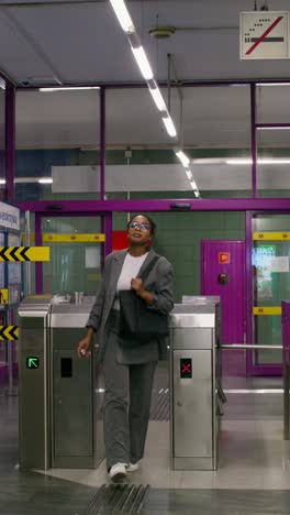 woman walking through a subway station