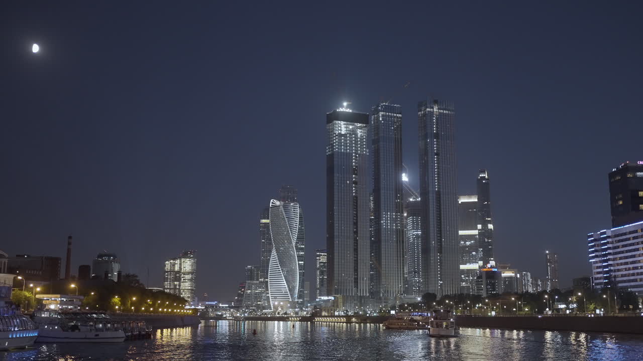 Night City Skyline with River and Boats