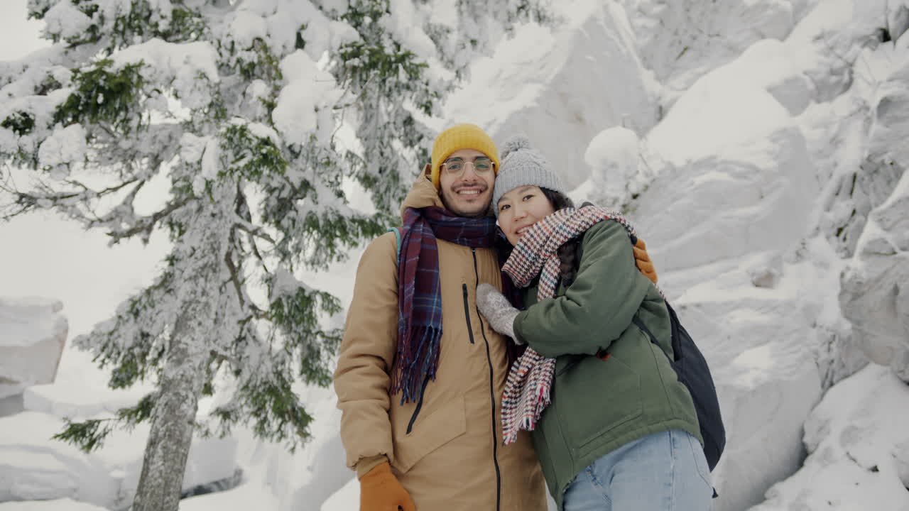 Couple Enjoying a Snowy Mountain Day