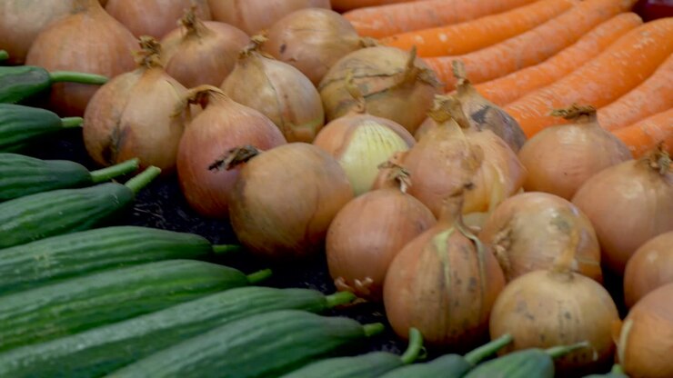 Fresh bio cucumber, onion and carrot on market