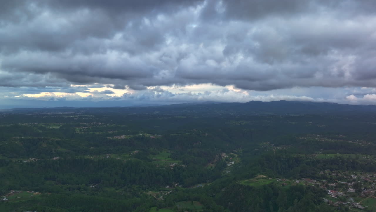 Drone timelapse of Chichicastenango’s mountains and forests beneath heavy storm clouds, creating a dramatic and moody aerial landscape
