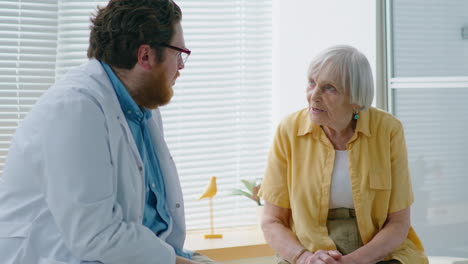 eldelry woman speaking with doctor in clinic