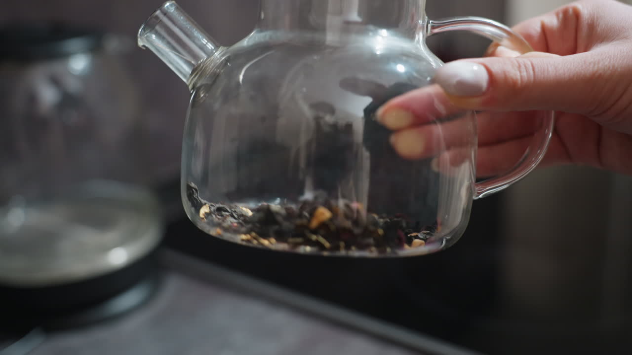 Colorful Petals In Glass Vessel, Close View Of Teapot Revealing Loose Herbs And Vibrant Petals, Studio Kitchen Scene With Glass Teapot Displaying Aromatic Loose Leaves And Bright Flower Petals