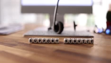 support service text on beads with office background
