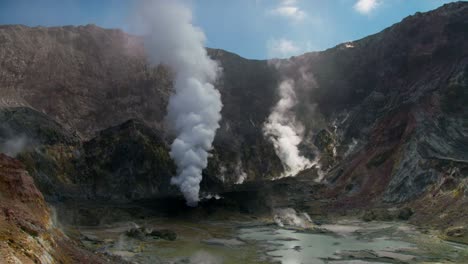 gas billowing in volcanic crater on whakaari white island, active volcano