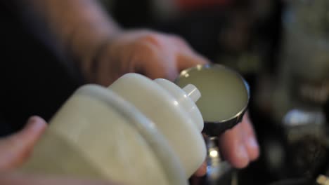 Process-of-preparing-cocktail,-pouring-syrup-into-measure-glass,-close-up