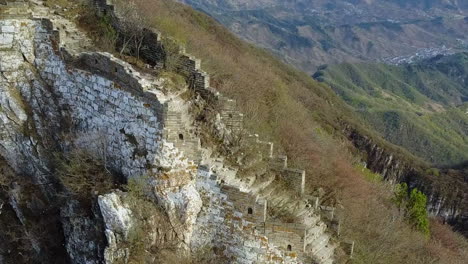 Grey-autumn-aerial-orbit:-Overgrown-wild-section,-Great-Wall-of-China