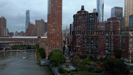 Aerial-drone-view-over-park-towards-Chambers-street,-in-Tribeca,-cloudy-New-York