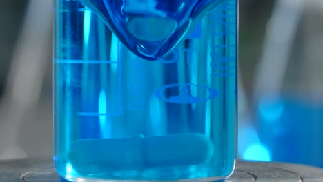 blue liquid in beaker in a laboratory setting