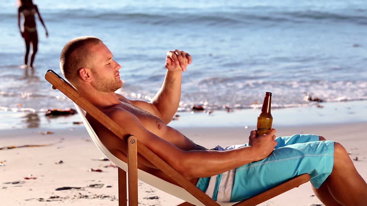 Young man sitting on the beach