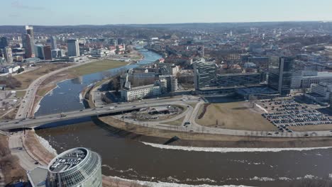 aerial: roundabout near river neris in vilnius with cars passing by