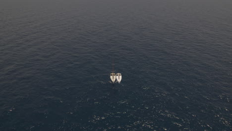 lonely-sailing-yacht-in-the-middle-of-a-flat-sea---drop-down-shot