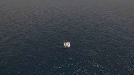 lonely sailing yacht in the middle of a flat sea - drop down shot