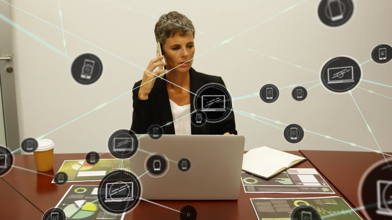 Animation of network of digital icons over caucasian businesswoman talking on smartphone at office
