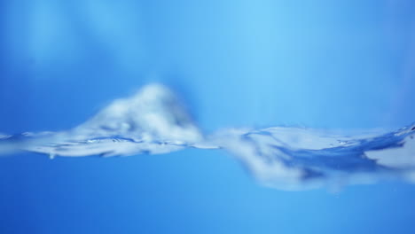 slow motion of water waves on surface with blue background