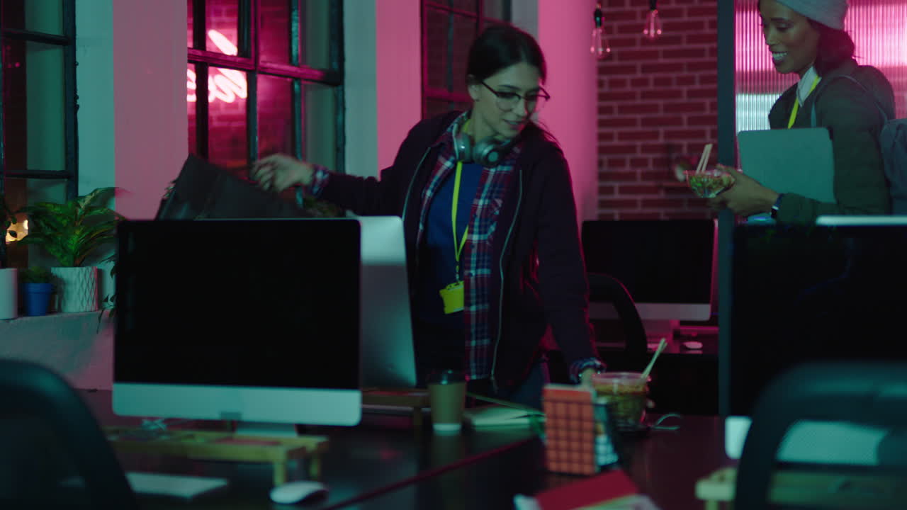 young business people working late leaving office colleagues finished successful project deadline teamwork in modern workplace at night