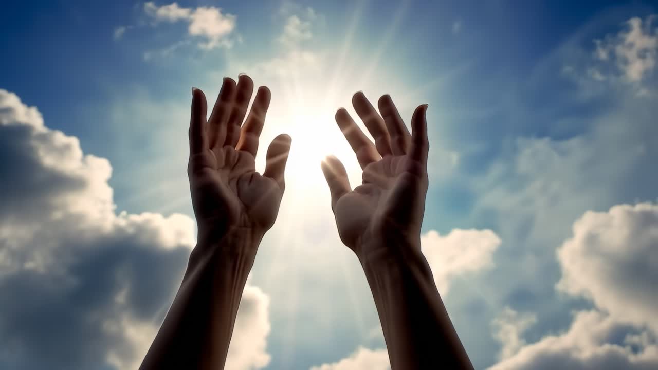 Upward angle captures hands reaching towards a bright sky, symbolizing hope and aspiration