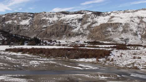 Snow-covered-mountains-and-a-winding-river-under-a-blue-sky-near-Chalten-in-Patagonia