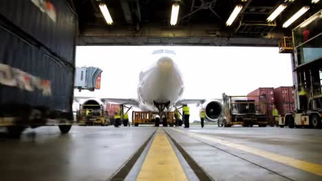 aircraft ground operations: coordinated efforts for efficient cargo handling and departure readiness in an airport hangar environment
