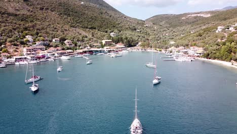 boat sails to harbour at mikros gialos, lefkada, greece - aerial