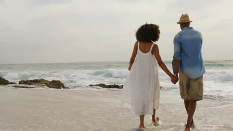 african american couple dancing together on the beach 4k