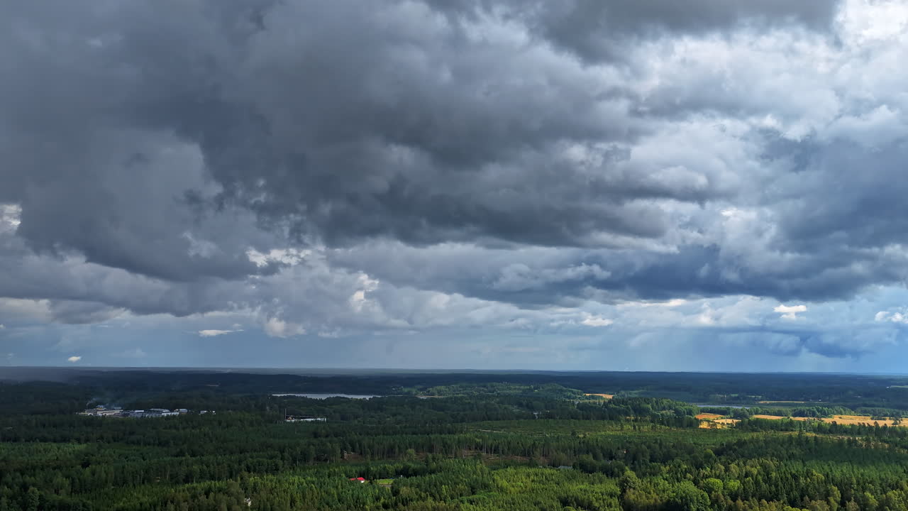 Hyperlapse drone shot rotating in front of storm clouds above the countyside